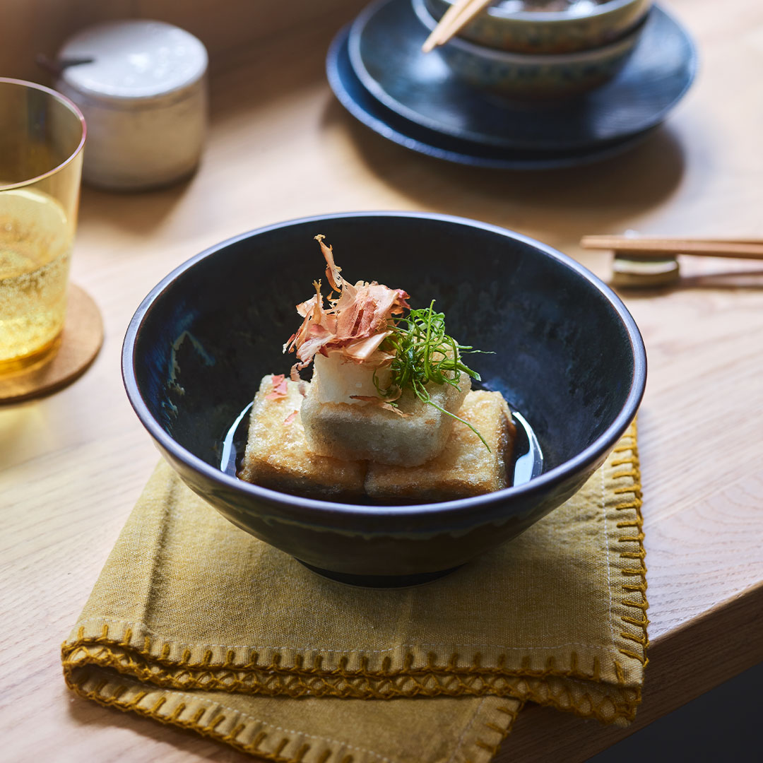 Agedashi tofu topped with bonito flakes and green onion