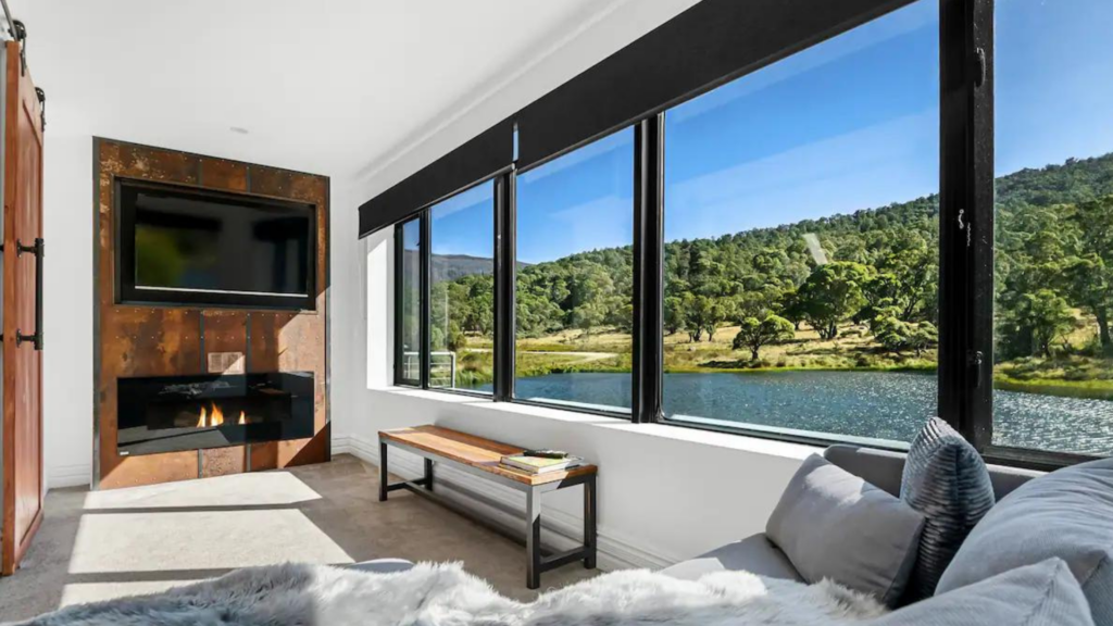 Jindabyne Airbnb interior with cosy indoor fireplace and lake view