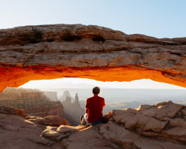 Man enjoying sunrise at Mesa arch, Canyonlands national park, Utah, USA