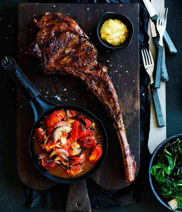 Tomahawk steak and roast tomatoes with rosemary